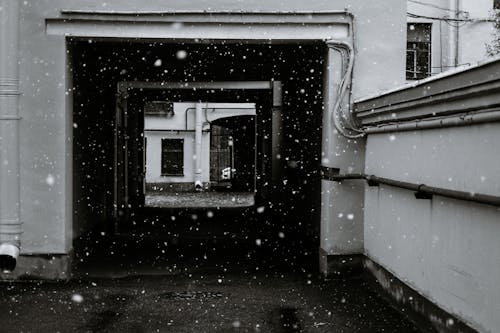 Walkway of shabby residential building in snowy day