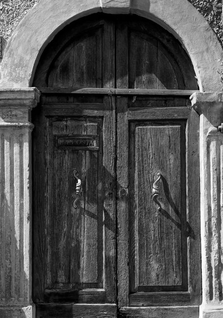 An elegant wooden door with archway from historic Verona, Italy.