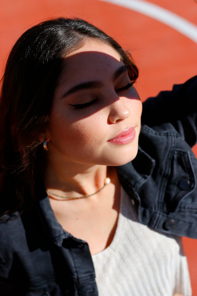 A Woman Blocking The Light From Face