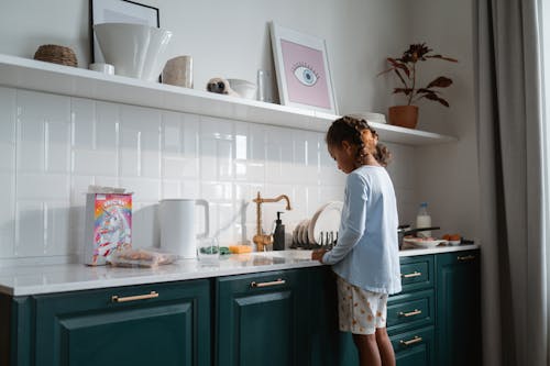 Free Girl Standing beside Kitchen Counter  Stock Photo