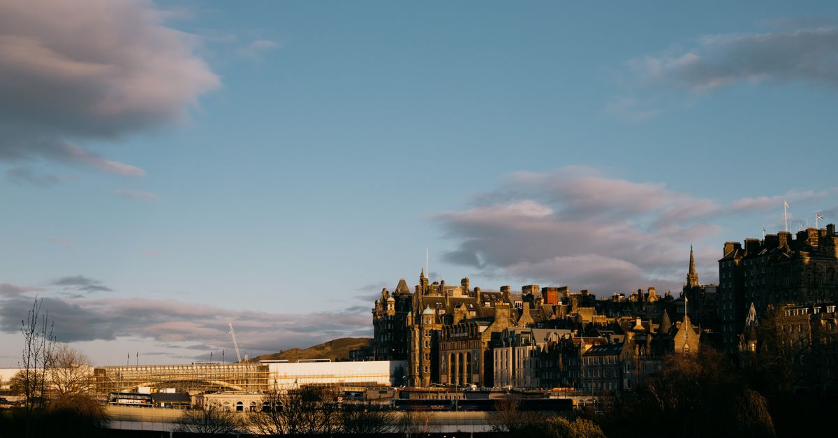 View of Edinburgh's historic architecture against a stunning sunset sky.
