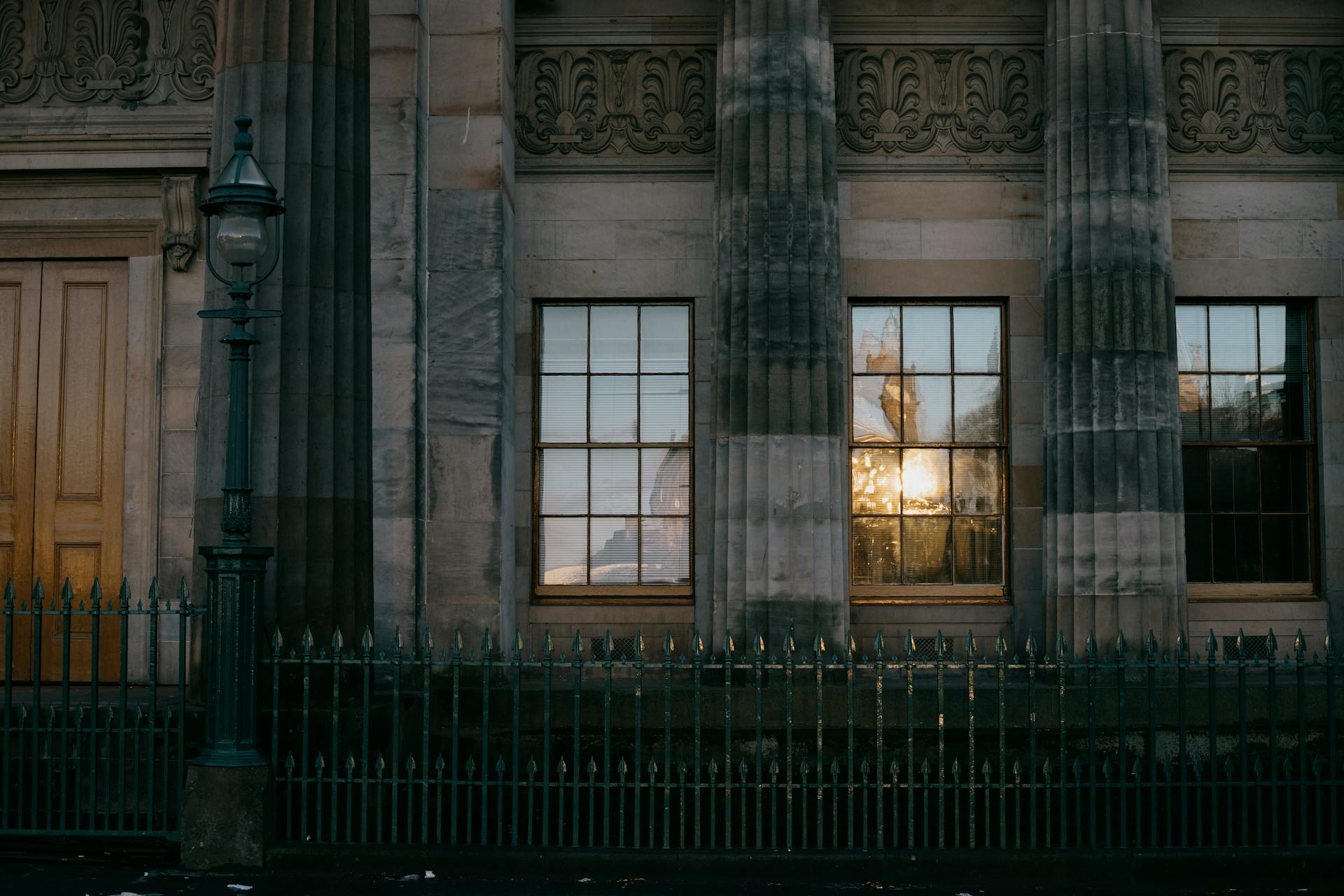 Facade of a neo-classical building in Edinburgh with reflections on windows.