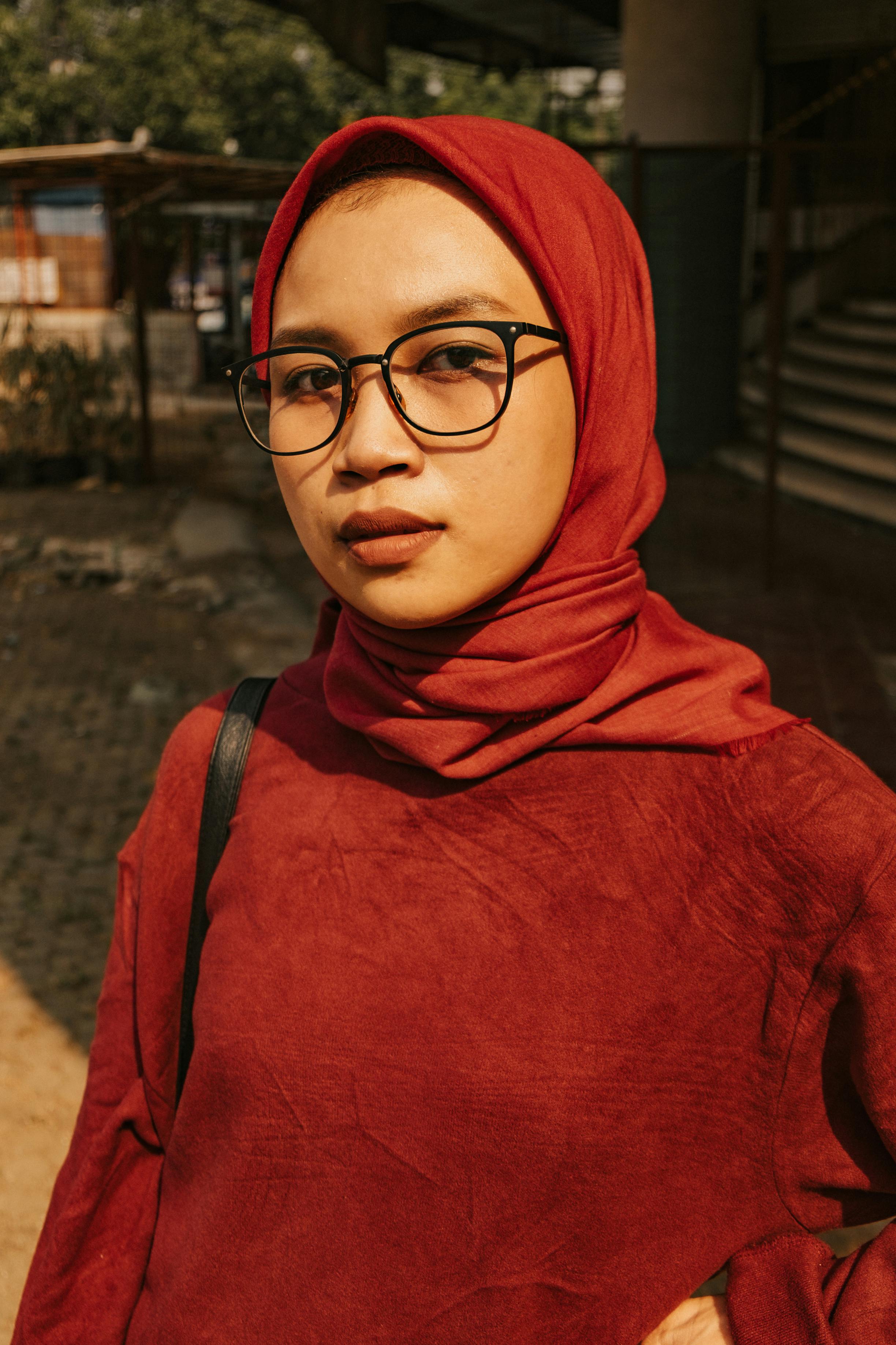 woman in red hijab wearing black framed eyeglasses