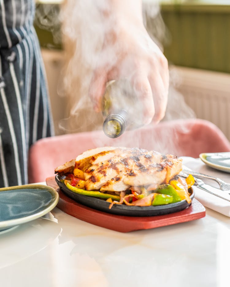 Cooked Food On Black Sizzling Plate