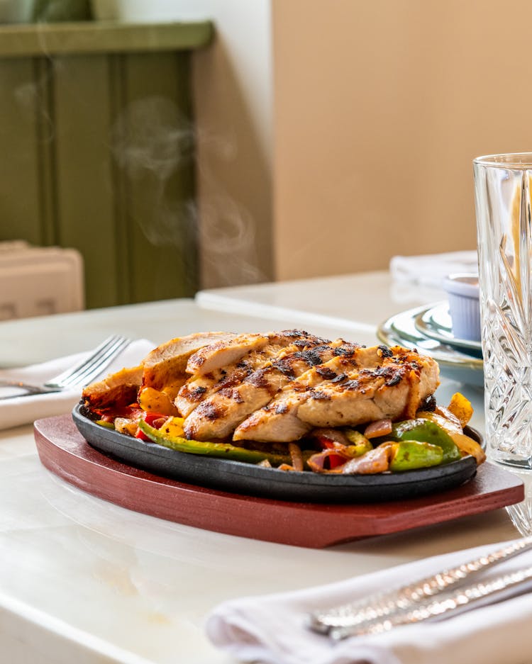 A Delicious Grilled Chicken On A Sizzling Plate