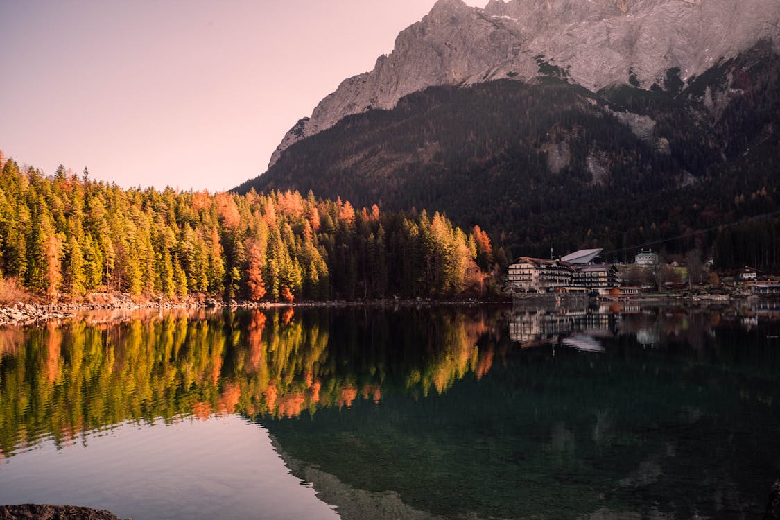 A Placid Lake Near Colorful Trees  During Autumn