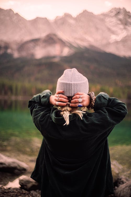 Free Person in Green Jacket and White Knit Cap Stock Photo
