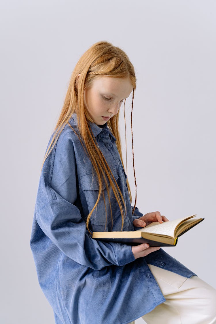 Girl In Blue Long Sleeves Reading A Book 