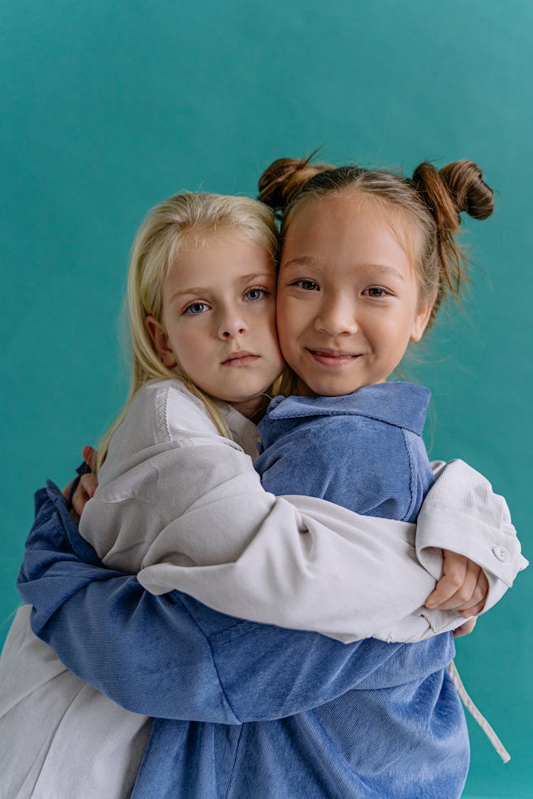 Girls Hugging On Green Background