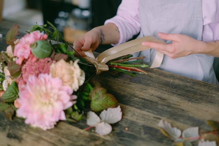 Person Arranging Bouquet Of Flowers