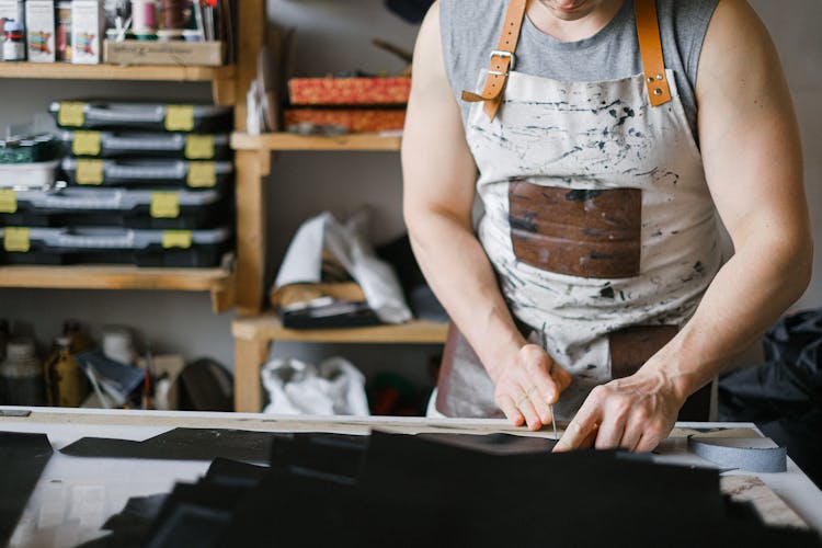 A Man Cutting Leather