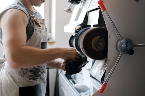 A Person Making Leather Shoes