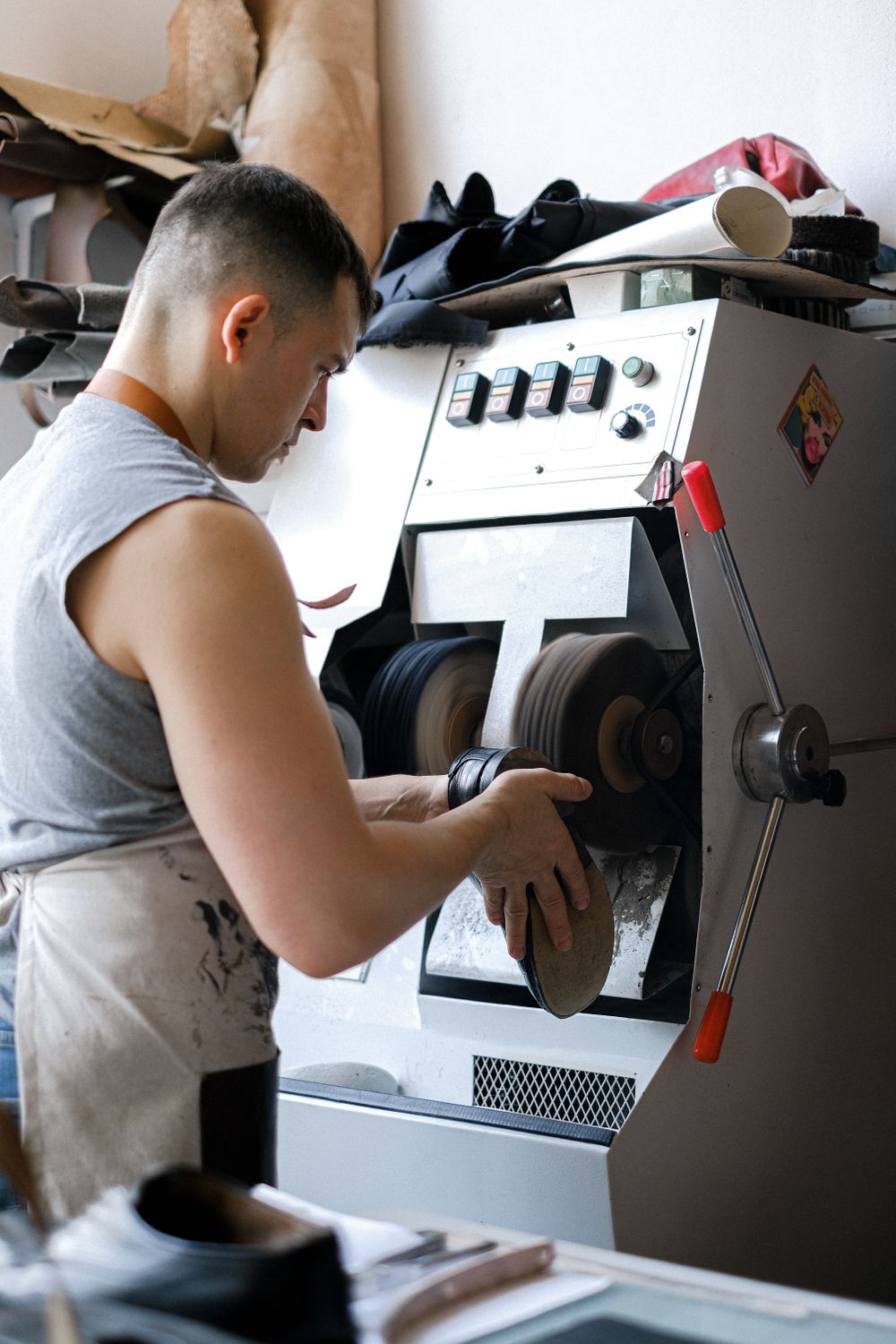 A sole being finished on a bench machine