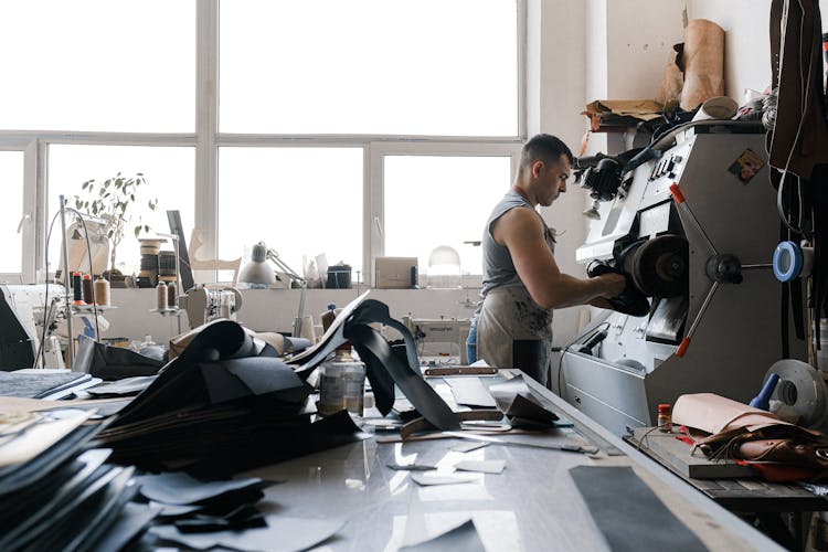 A Person Sanding The Leather Shoes