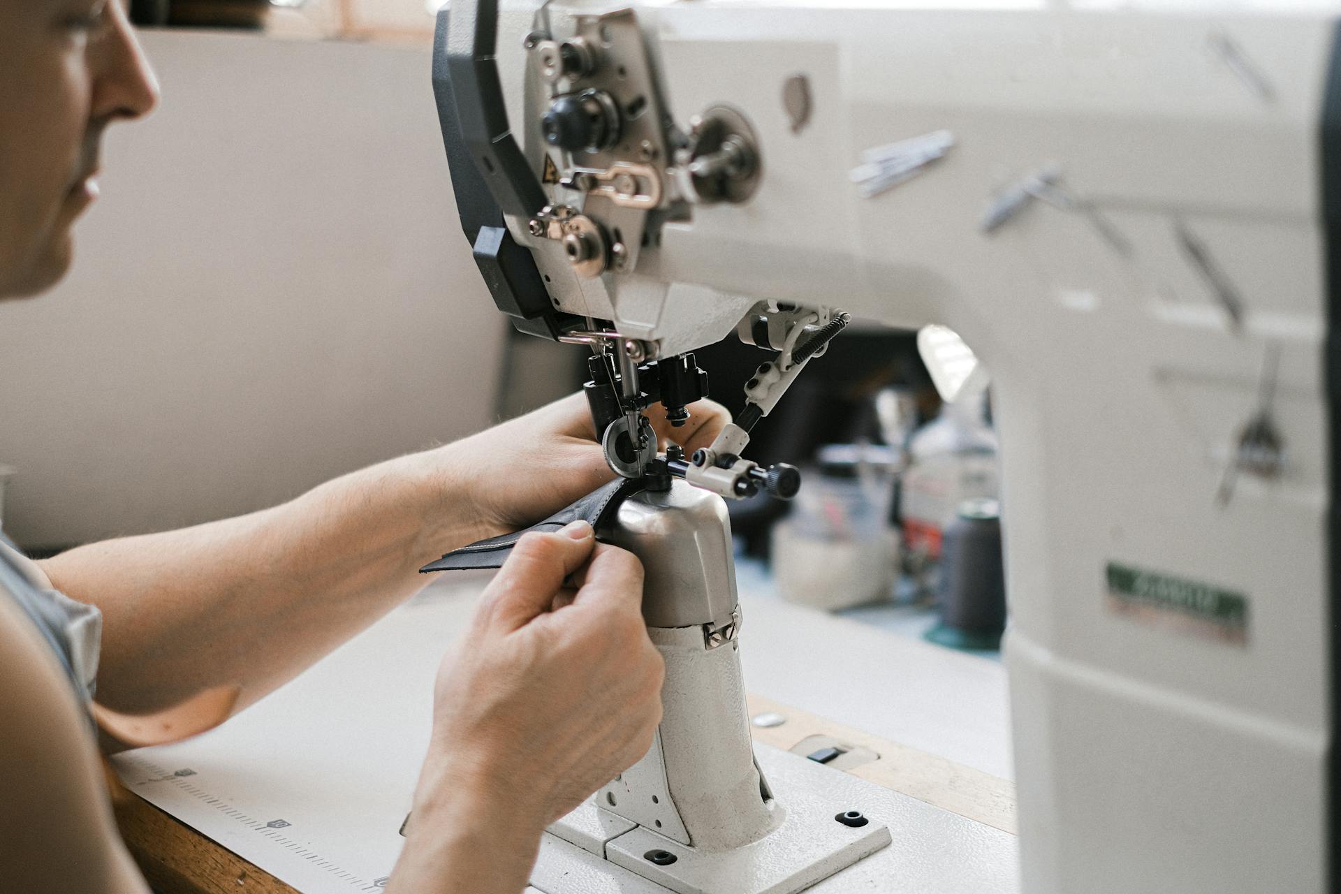 A Man Sewing Using Industrial Sewing Machine