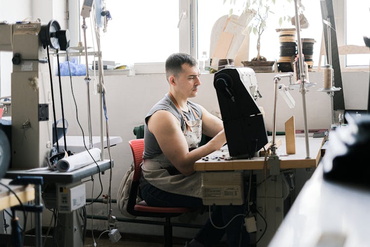 A Man Using Industrial Sewing Machine