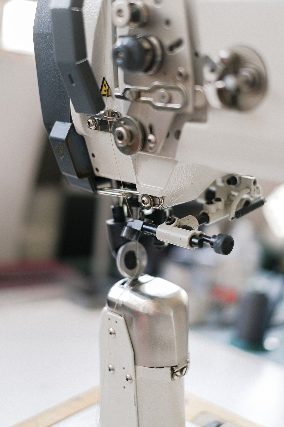 Close-up of an industrial sewing machine in a workshop