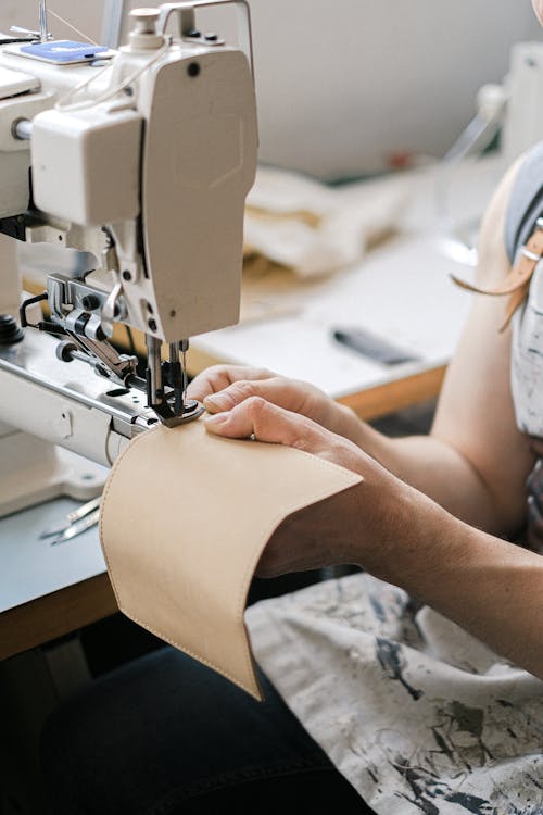 Free A Person Sewing Using Industrial Sewing Machine Stock Photo