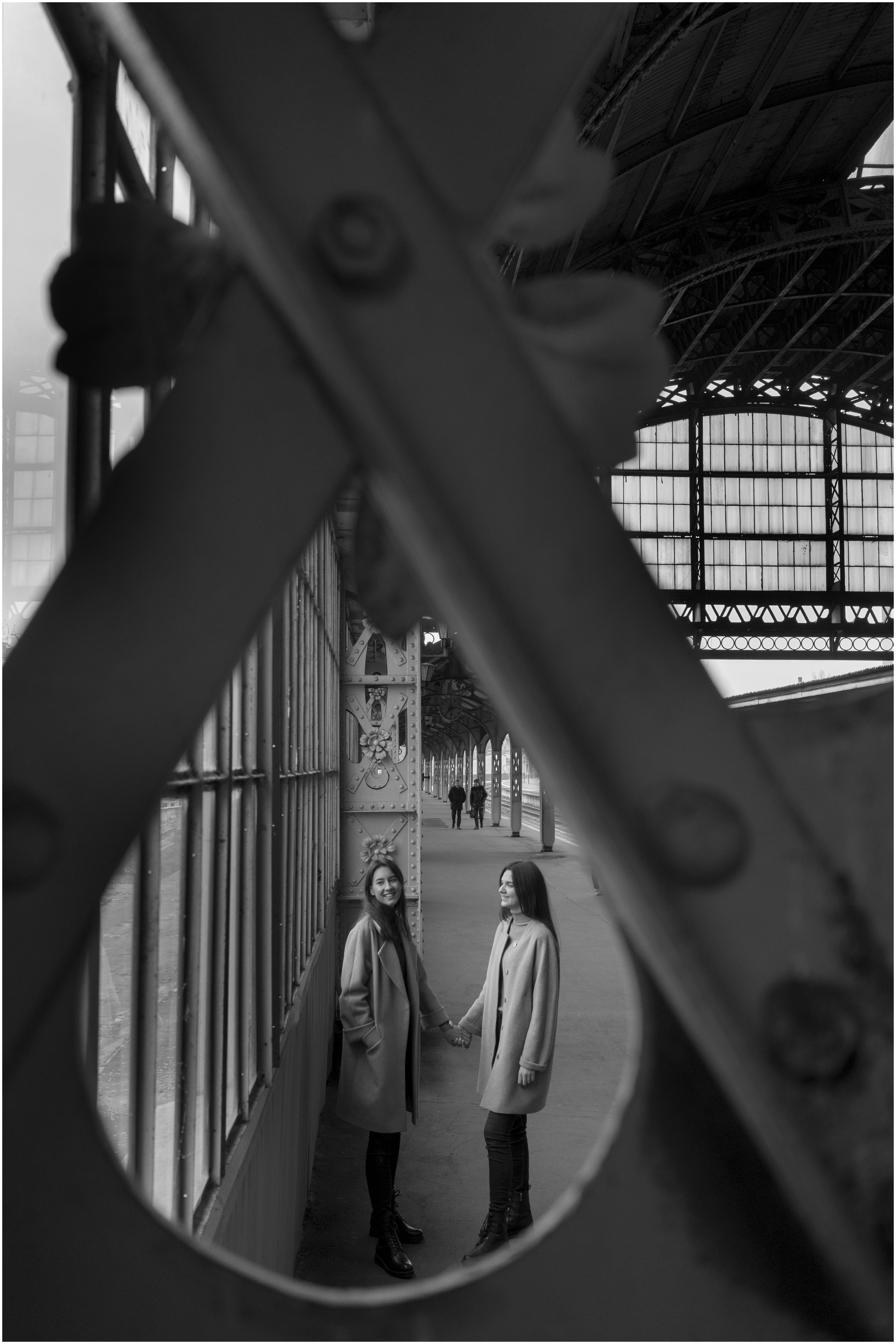 lesbian couple holding hands on platform