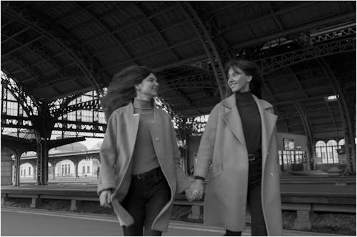 Stylish couple walking on railway station