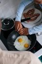 A Kid Cooking Eggs