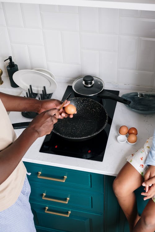 Free A Person Cracking Egg with a Knife Stock Photo