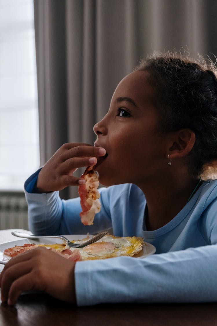 A Girl Eating Bacon