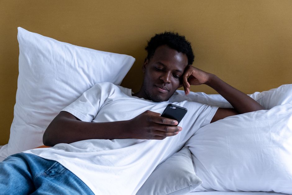 Person calmly looking at their phone - buttock intramuscular injection site Person calmly looking at their phone - buttock intramuscular injection site