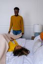 Man in Yellow Sweater and Blue Denim Jeans Lying on Bed