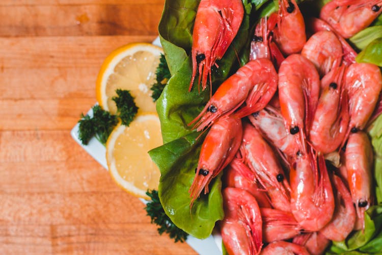 Tasty Cooked Shrimps With Cut Fresh Lemon On Plate