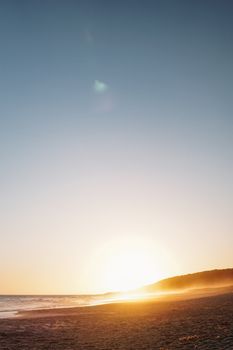 Beautiful beach sunset with golden hour hues, capturing the soothing waves and expansive sky.