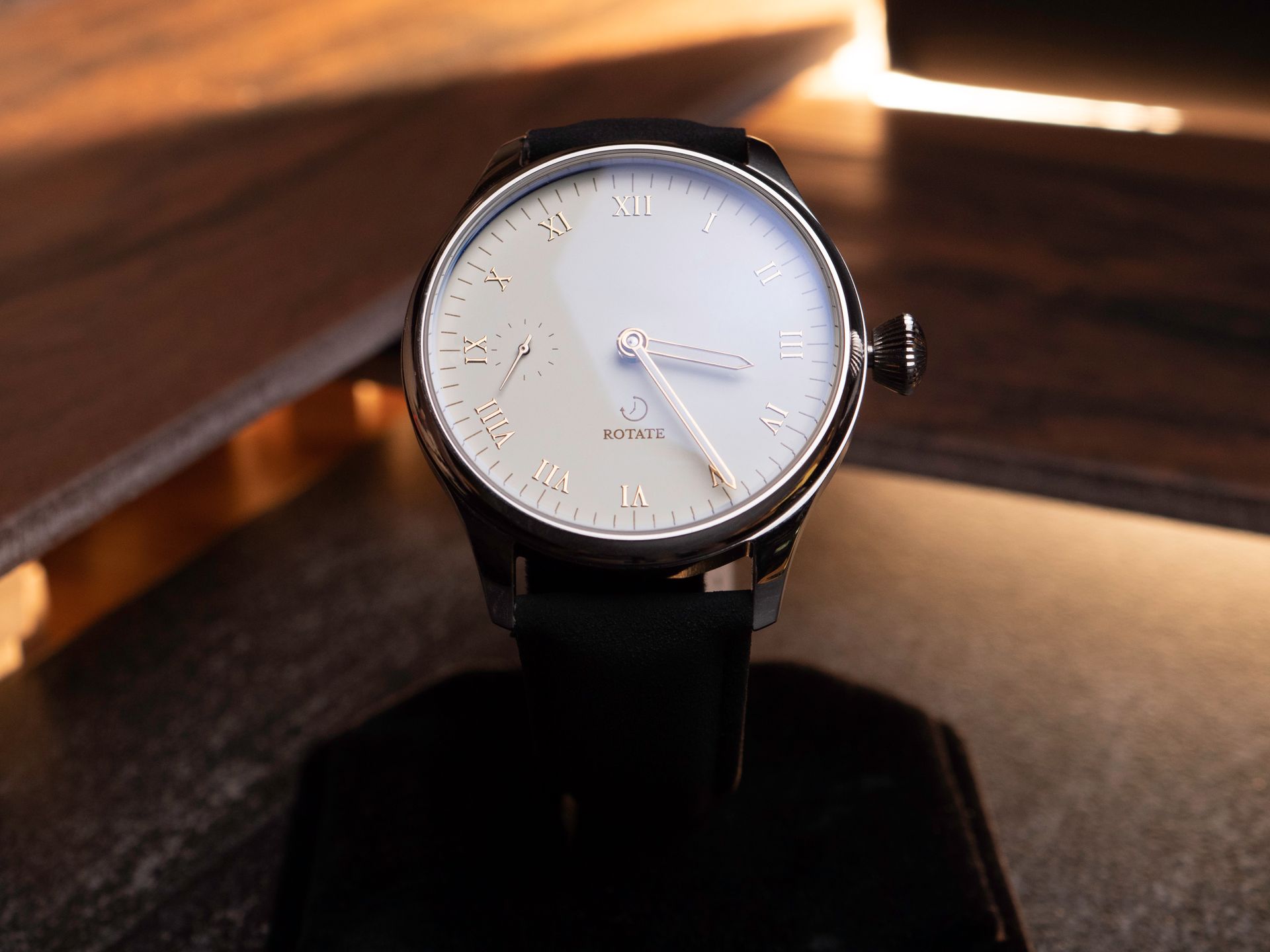 Close-up of an elegant wristwatch showcasing Roman numerals and classic analog design.