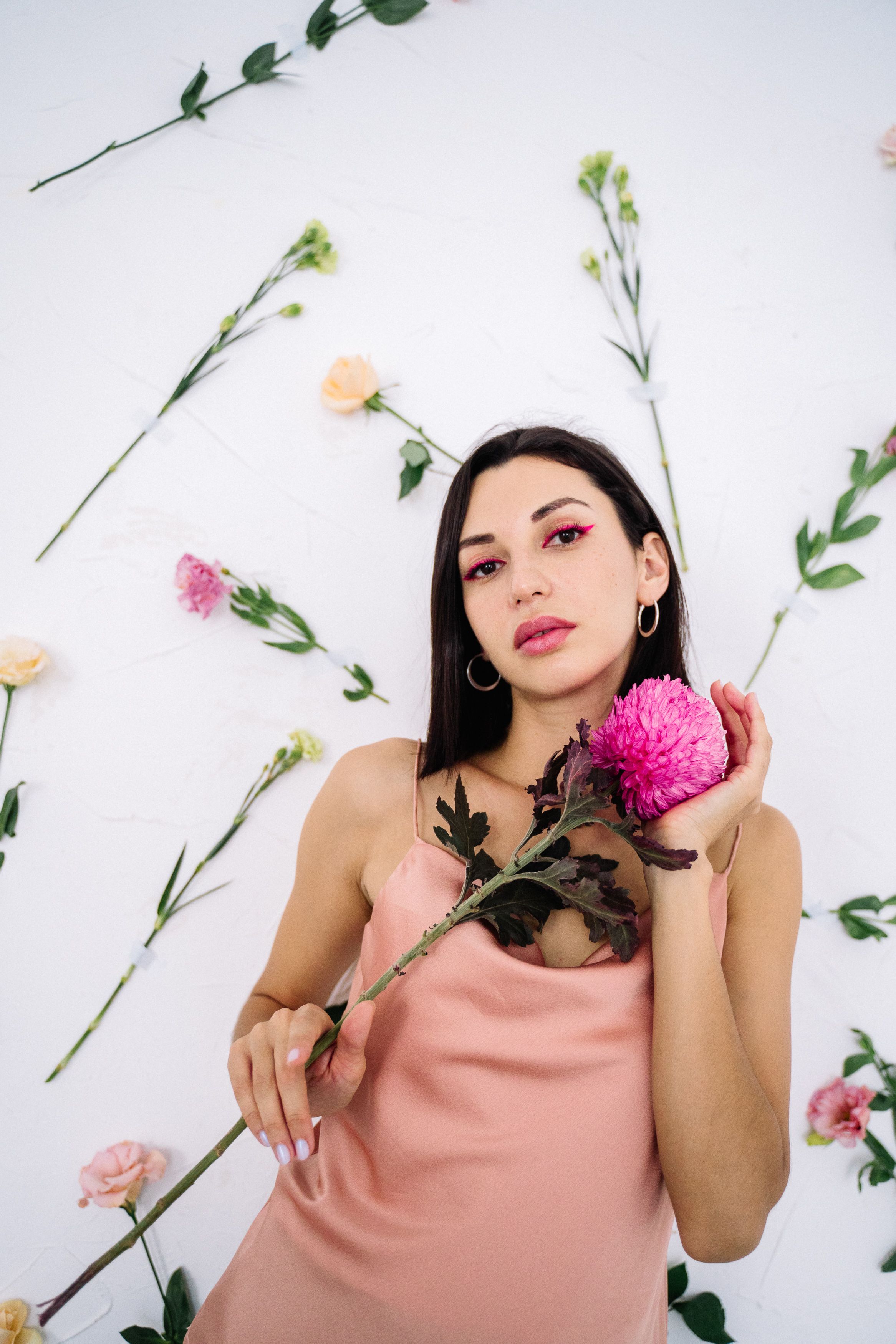 Woman in Pink Tank Top Holding Pink Flower · Free Stock Photo