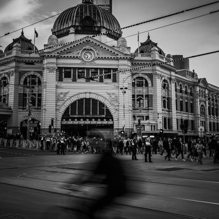 Grayscale Photo Of People Walking On Flinders Street Station