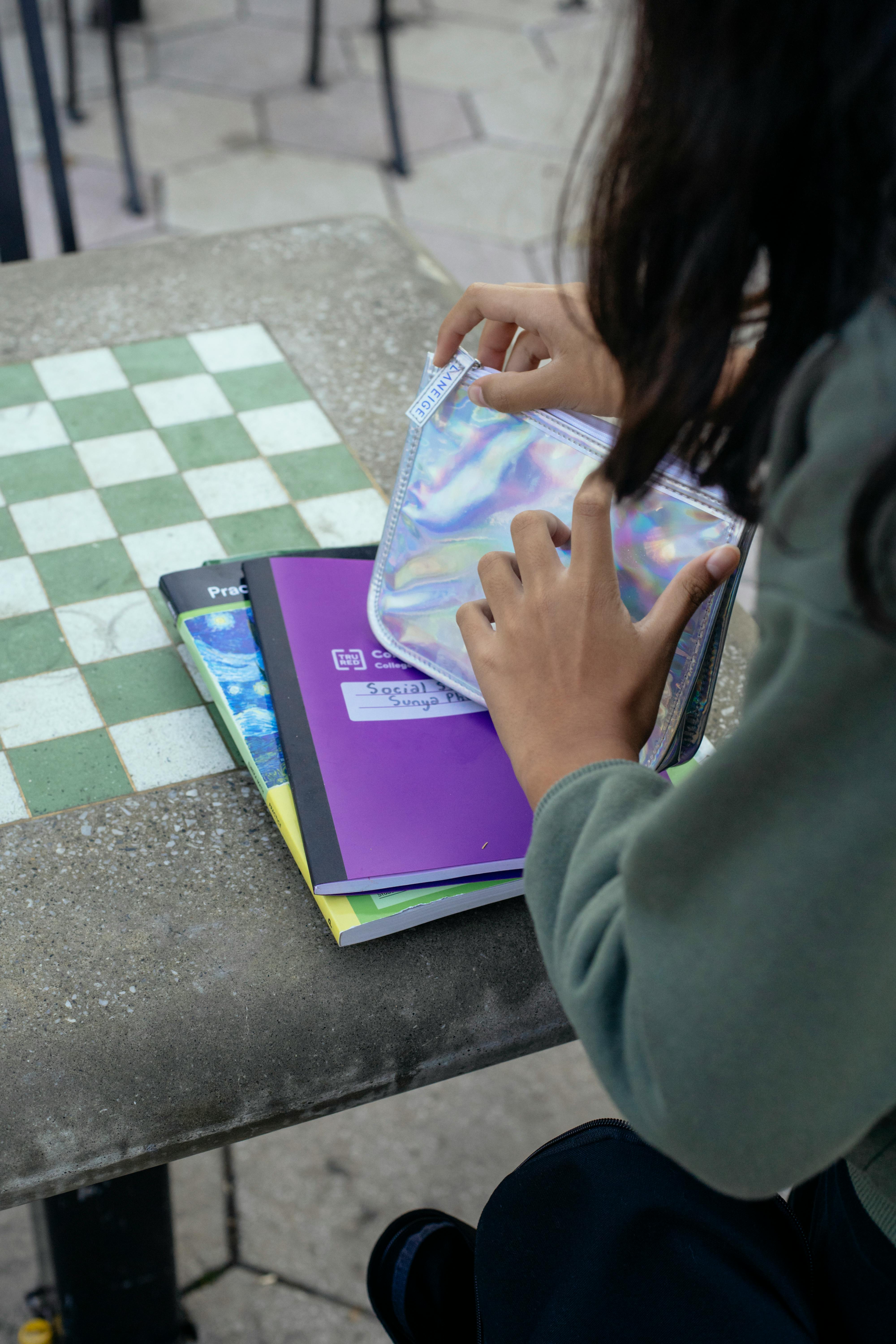 crop teen girl studying in park