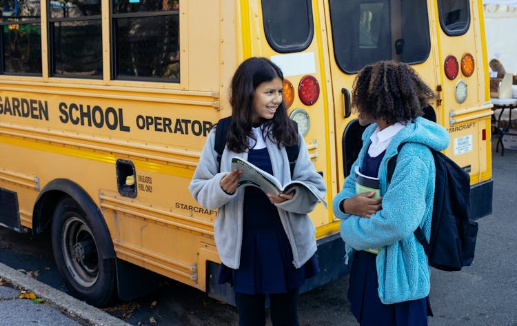 Cute Diverse Children Near School Bus