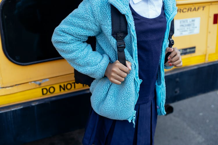 Crop Ethnic Schoolkid With Backpack On City Road