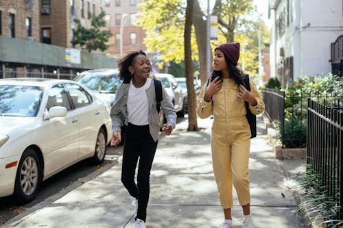 Free Best multiethnic friends talking and walking on street Stock Photo