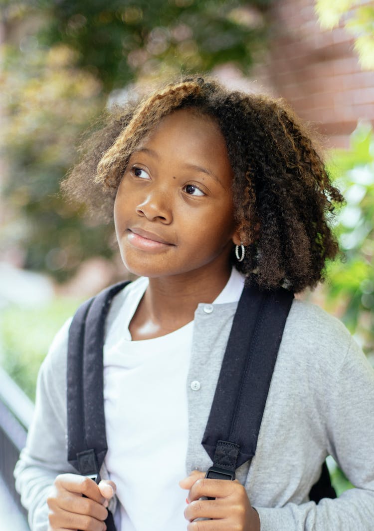 Dreamy Black Schoolgirl With Rucksack On City Street