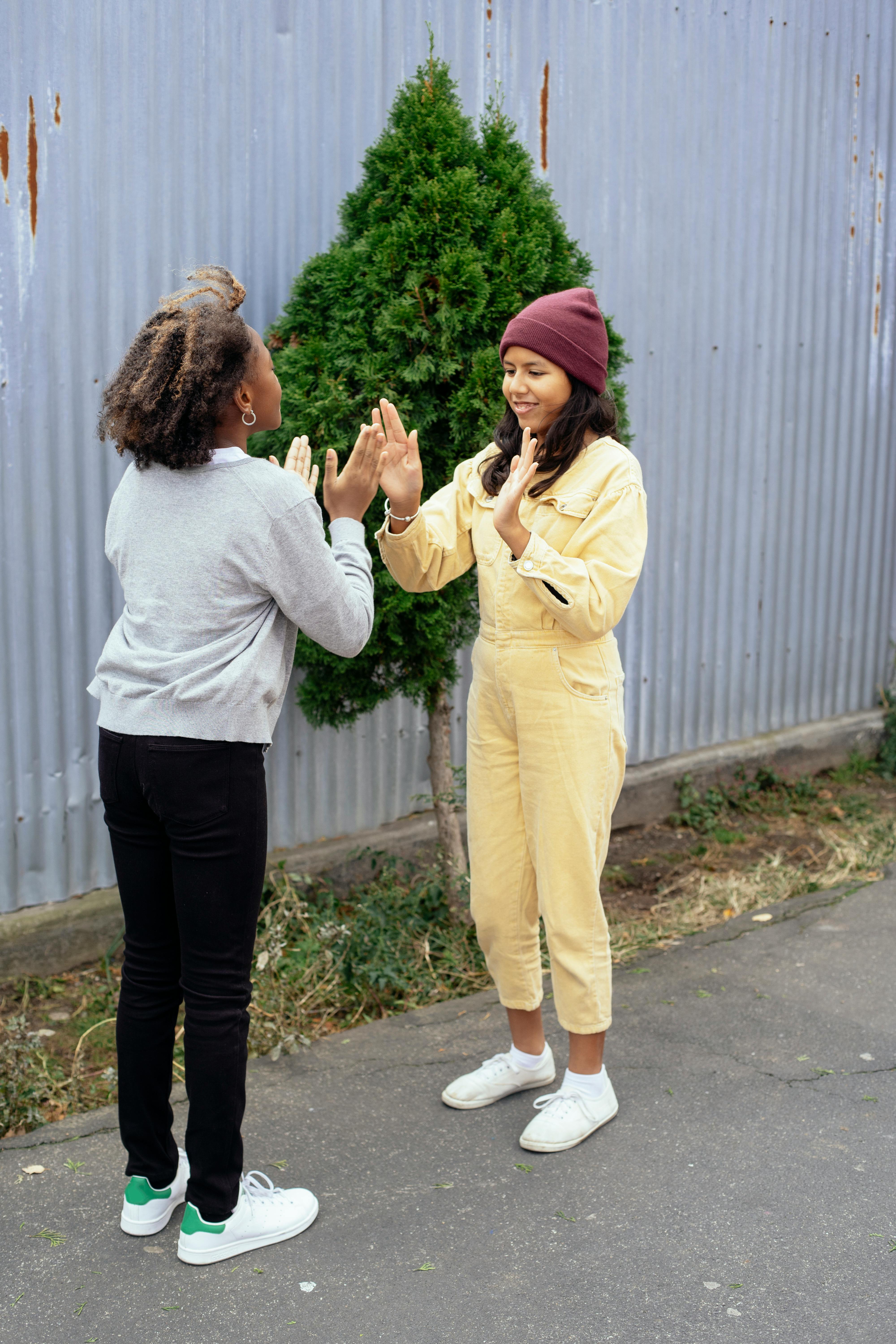 cheerful girls playing game with hands