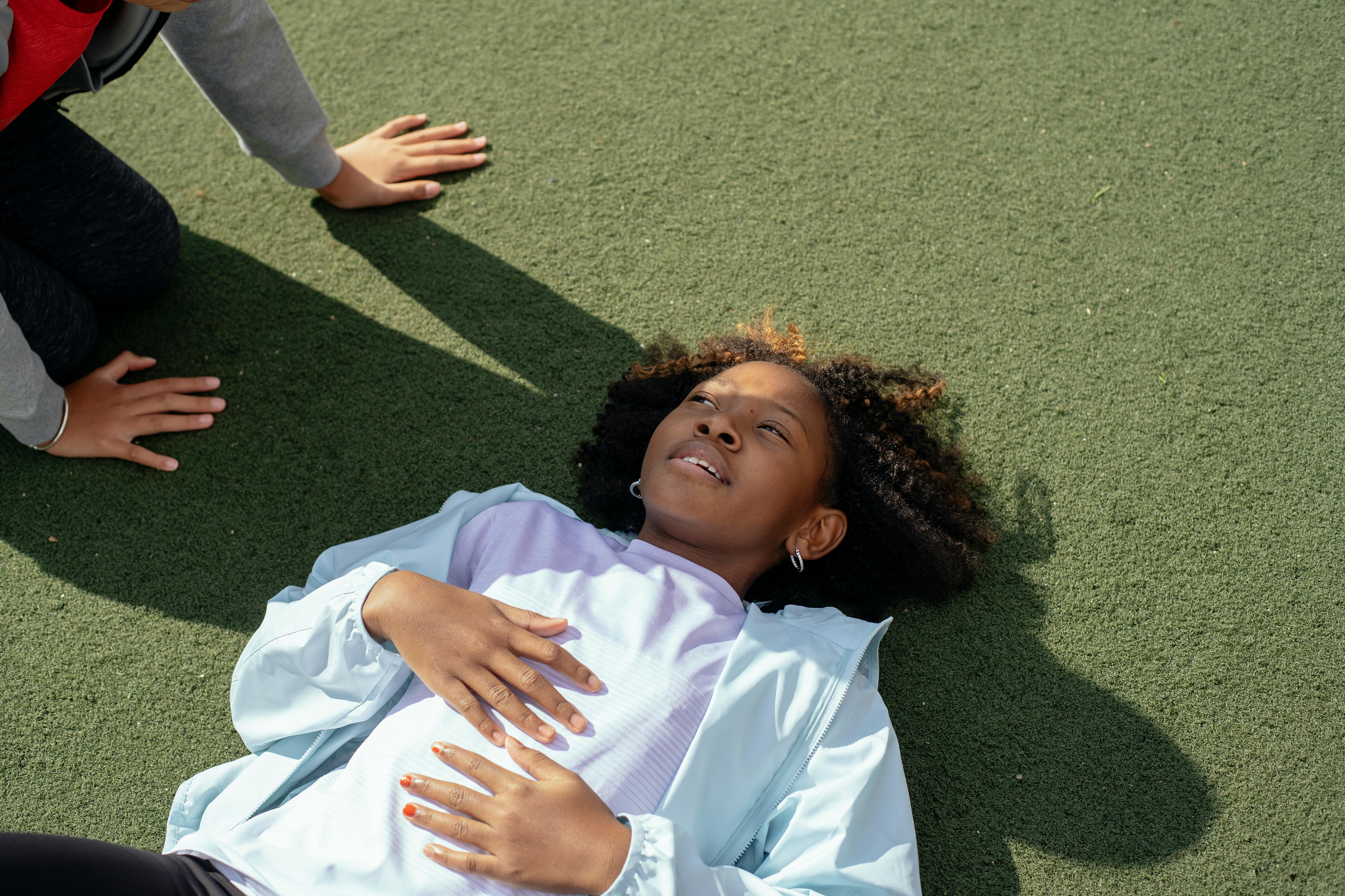 black girl with faceless friend on stadium