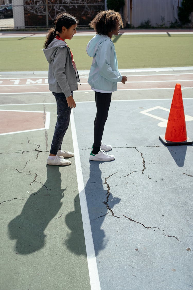 Active Girls Playing On Playground Located In Backyard Of School