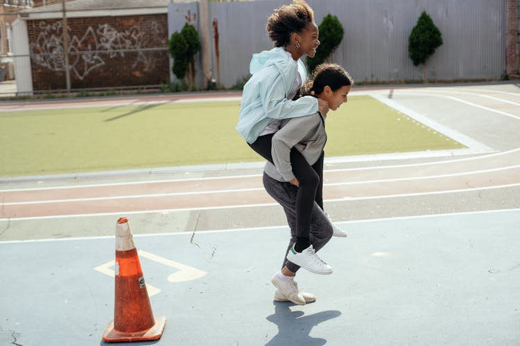 Diverse Classmates Having Fun On School Sports Ground