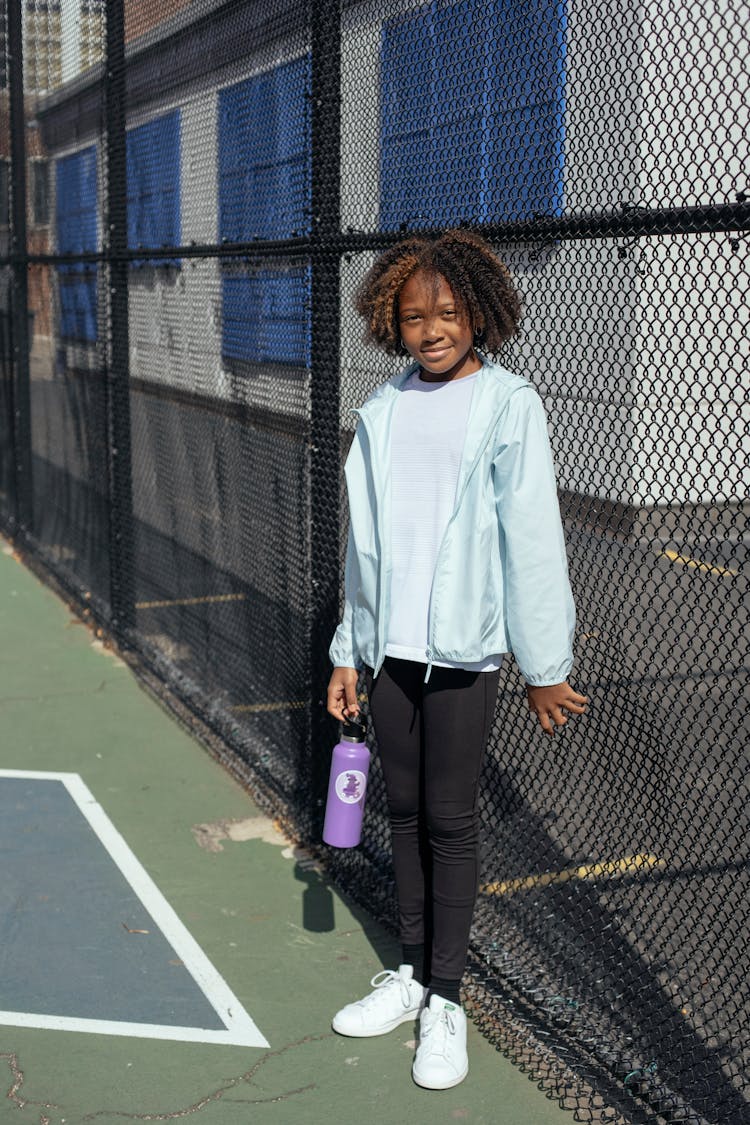 Cheerful Black Girl On Sports Ground