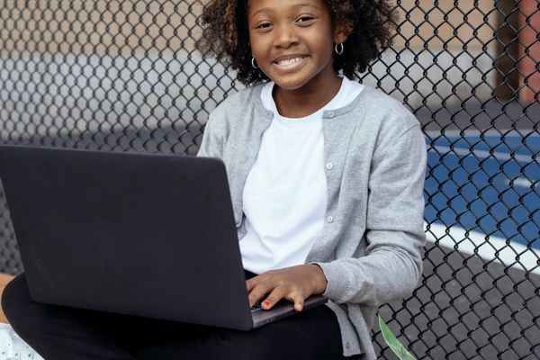 A student studying with a laptop and textbook