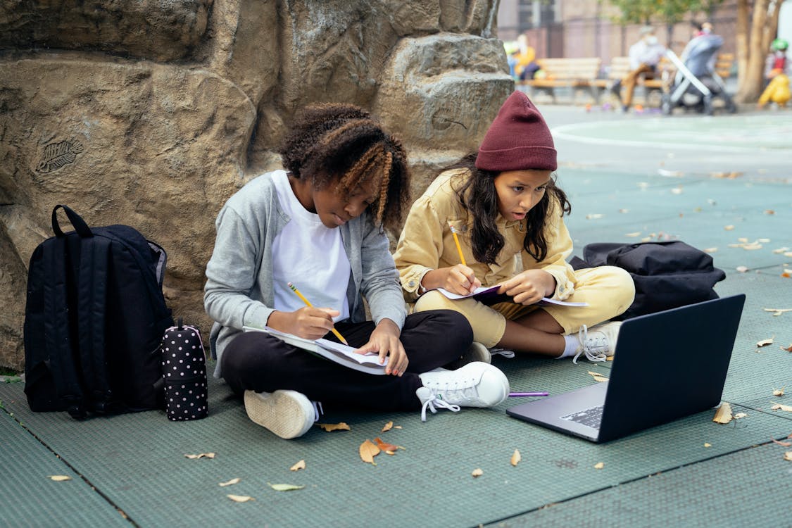 Concentrated diverse schoolgirls doing homework