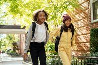 Cheerful friends walking together in sunny day