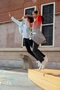 Happy girls jumping on ground