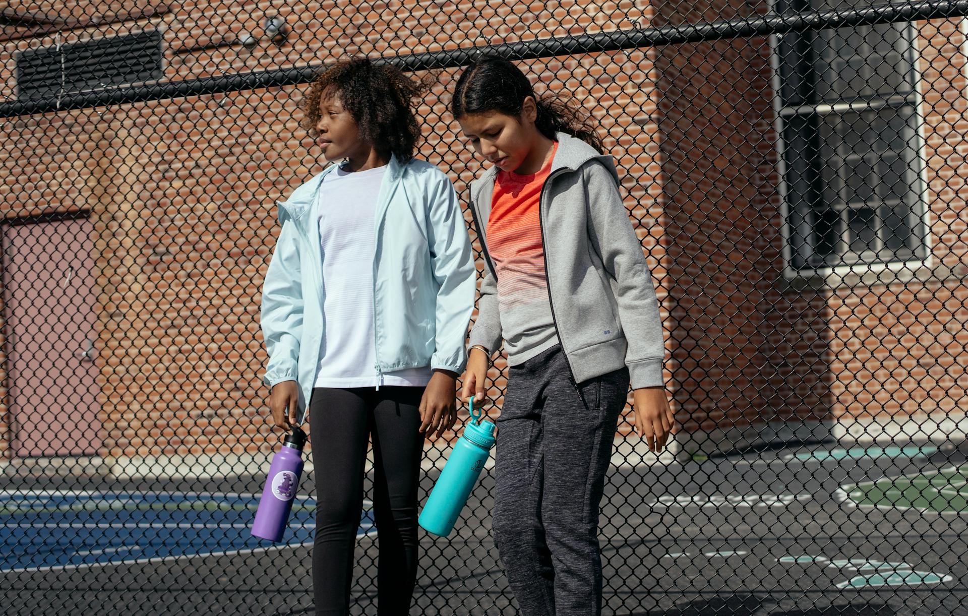 Diverse sportswomen with plastic bottles