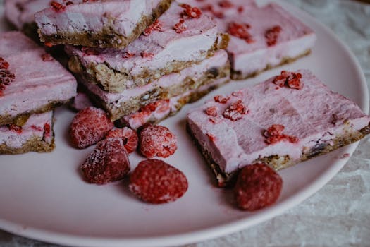 Close-up of raspberry frozen dessert bars with fresh raspberries.